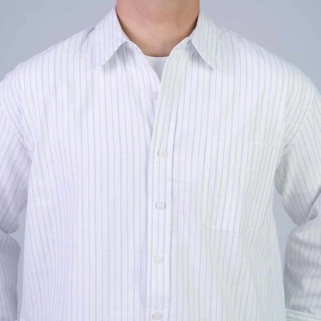 Rare boxy fit striped shirt with long sleeves and a classic collar, featuring blue and white horizontal stripes.