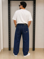 Rare STWD jeans displayed on a hanger, showcasing classic denim fabric and modern fit with visible stitching details.