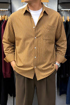 Rare boxy fit striped shirt with long sleeves and classic collar, shown on a white background.