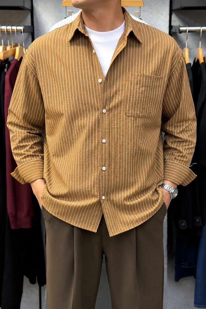 Rare boxy fit striped shirt with long sleeves and classic collar, shown on a white background.