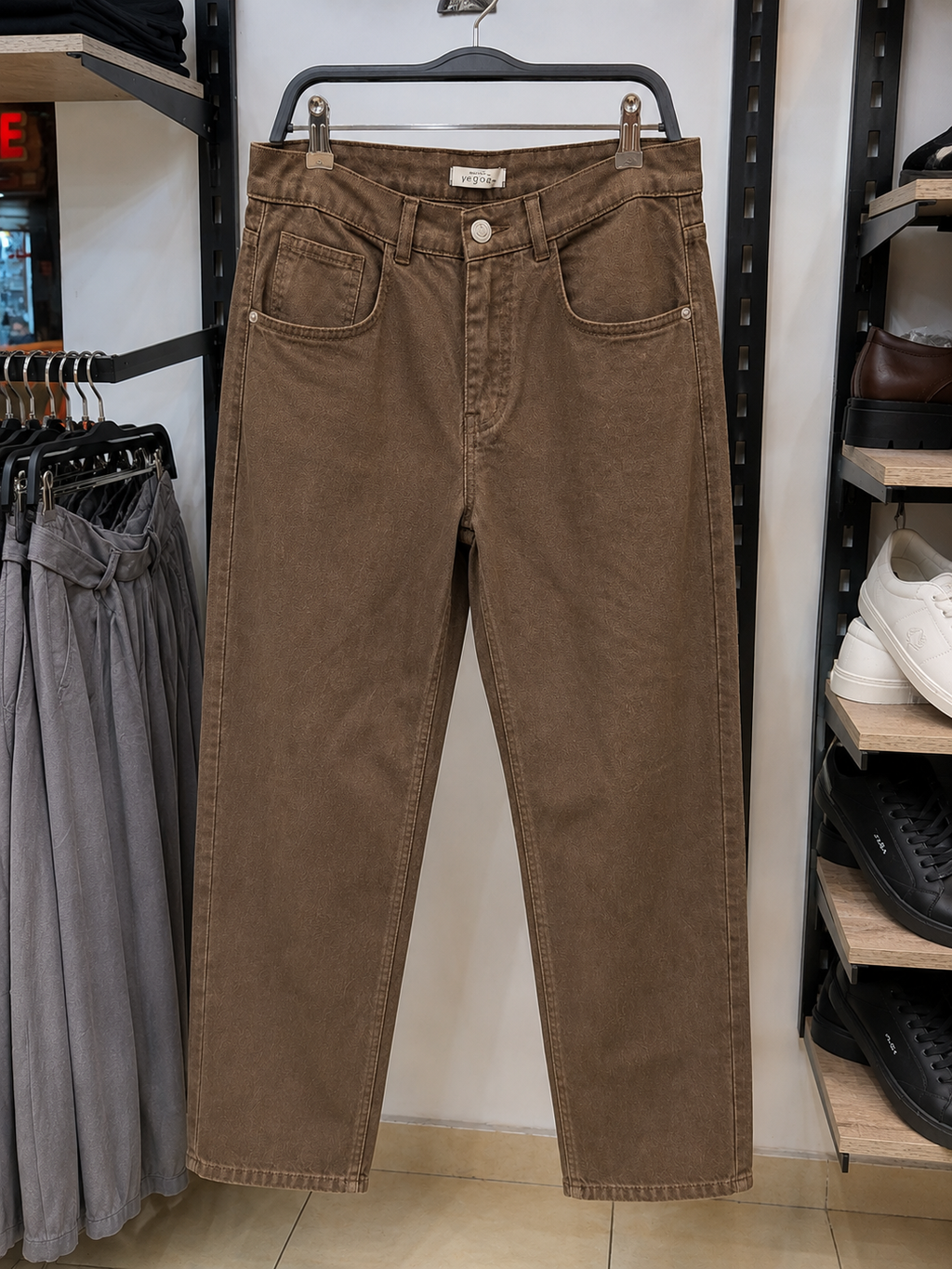 Rare brown washed jeans showing a relaxed fit, classic five-pocket design, and distressed detailing on the denim fabric.