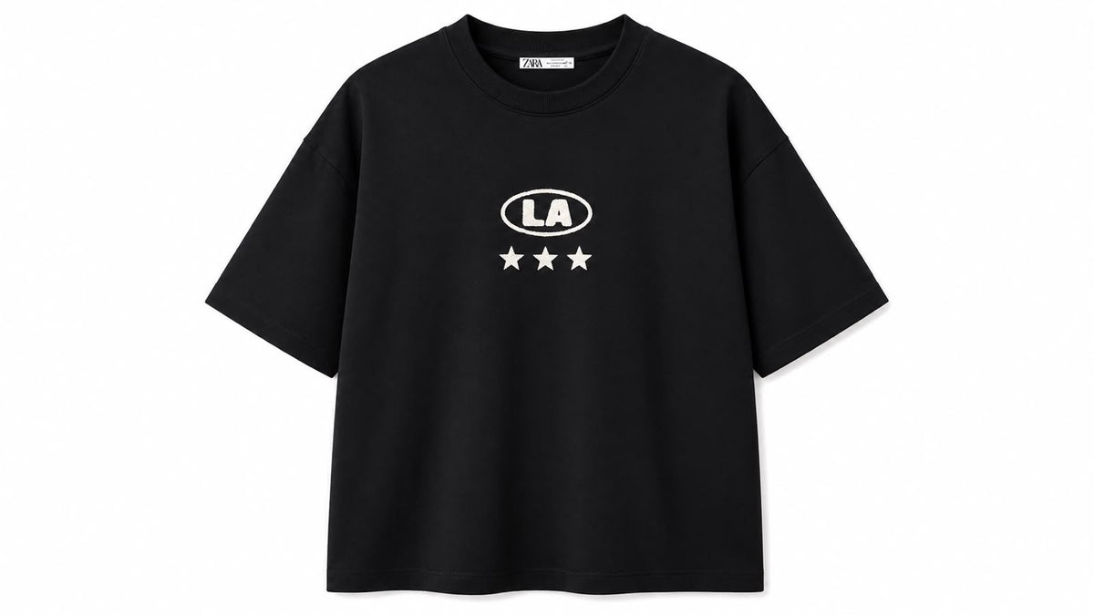 Black oversized graphic tee by rare with bold design on front, relaxed fit, casual style, laid flat for display.