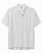 Rare short-sleeve textured button shirt displayed on a hanger, featuring a subtle pattern and classic collar detail.