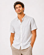 Rare short-sleeve textured button-up shirt with a classic collar and subtle fabric pattern, displayed on a hanger.
