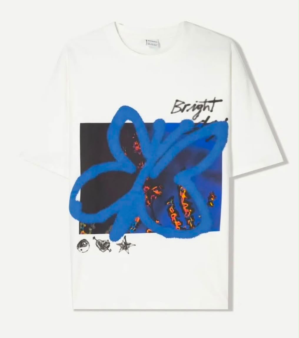 Bright blue graphic oversized tee by rare, featuring a bold white design, laid flat to showcase the relaxed fit and vibrant color.