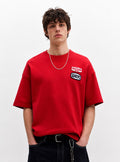 Red athletic graphic T-shirt with number 28 and brand rare logo, displayed on a plain background.