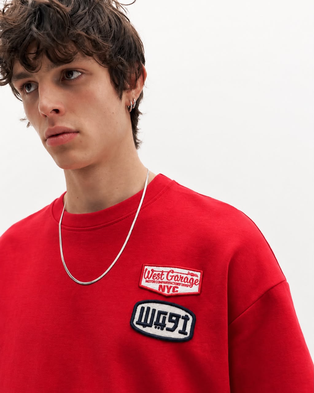 Red athletic graphic T-shirt with number 28 and rare brand logo, casual fit, worn by a person in a close-up front view.