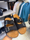 Black double-strap sandal from rare, featuring two adjustable straps and a sleek design, shown on a neutral background.