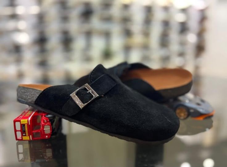 Black Glogges by Rare featuring a sleek black design with textured details and a comfortable fit.