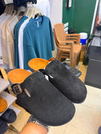 Black Glogges by Rare, stylish and comfortable black slippers with a sleek design, perfect for casual wear.