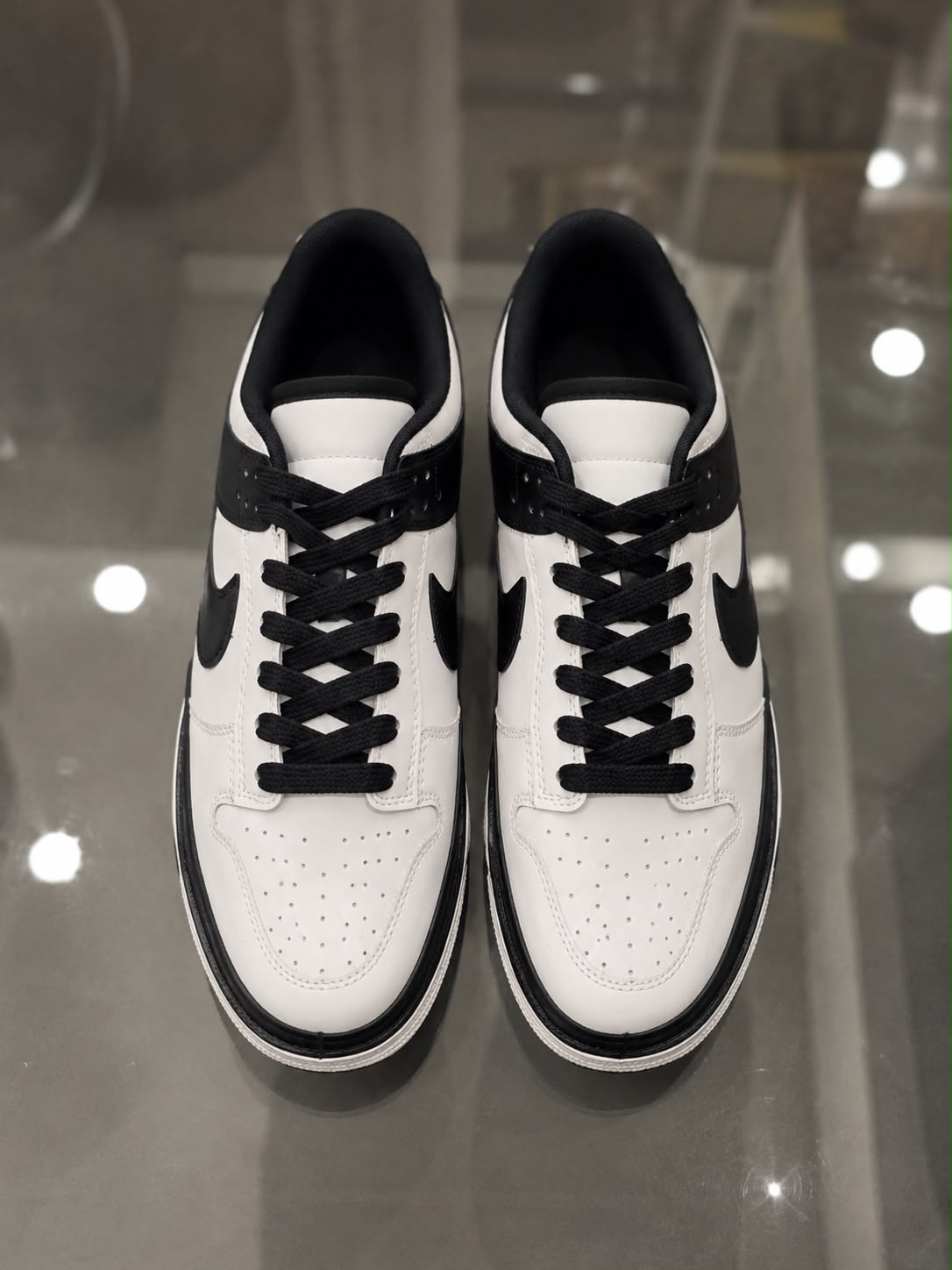 Rare Nike SB Mirror sneaker with reflective silver upper, showcasing its stylish design and textured sole in a close-up shot.