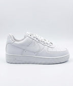 Rare Nike white Air Force sneakers shown in a clear side view, highlighting the classic design and clean white leather upper.