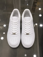 Rare Nike white Air Force sneakers, close-up view showing clean leather upper and classic design.