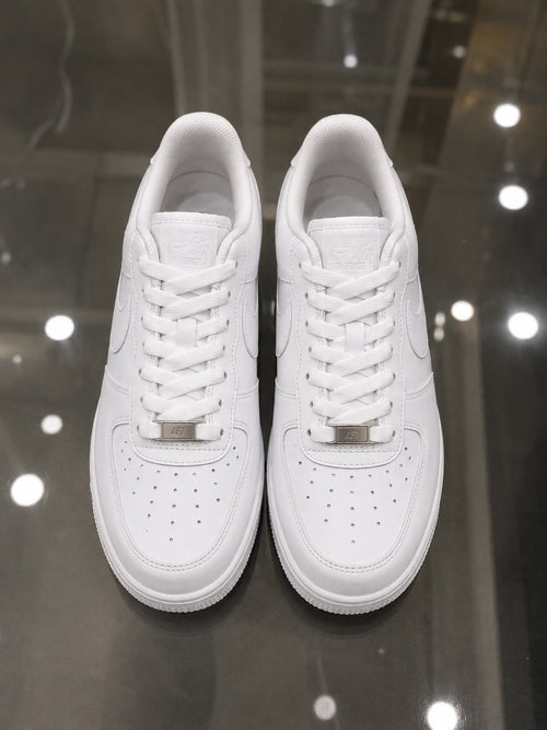 Rare Nike white Air Force sneakers, close-up view showing clean leather upper and classic design.