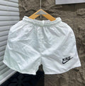 Rare swimsuit shorts shown on a model, featuring a stylish design with a comfortable fit for beach or poolside wear.