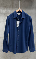 Light beige Rare linen shirt displayed on a hanger, showcasing its relaxed fit and breathable fabric for casual wear.