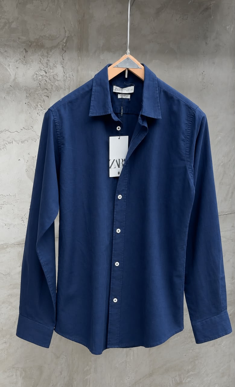 Light beige Rare linen shirt displayed on a hanger, showcasing its relaxed fit and breathable fabric for casual wear.