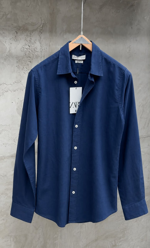 Light beige Rare linen shirt displayed on a hanger, showcasing its relaxed fit and breathable fabric for casual wear.