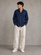 Rare linen shirt displayed on a hanger, showcasing lightweight, breathable fabric and classic design for casual or summer wear.