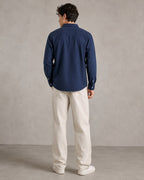 Rare linen shirt displayed on a hanger, showcasing lightweight, breathable fabric with a classic collar and button-down design.