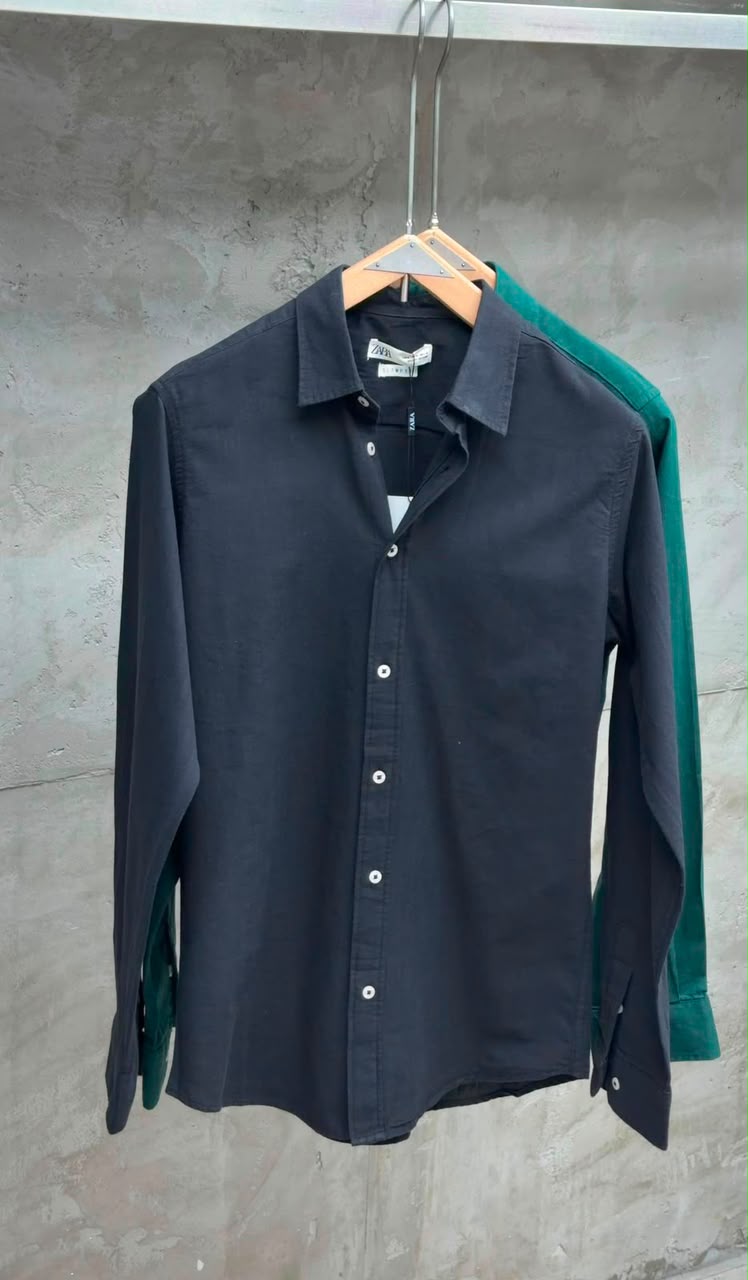 Rare linen shirt displayed on a hanger with a light, breathable fabric and a relaxed fit in natural linen color.