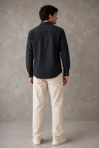 Rare linen shirt displayed on a hanger, showcasing its lightweight, breathable fabric and classic casual style.