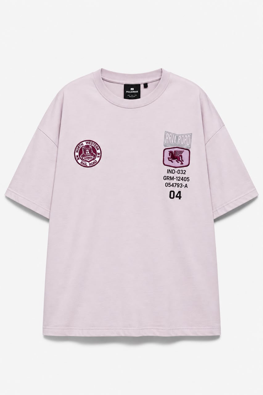 Rare Rail Road Tee shown hanging on a hanger, featuring a classic design with railroad graphic and casual fit.